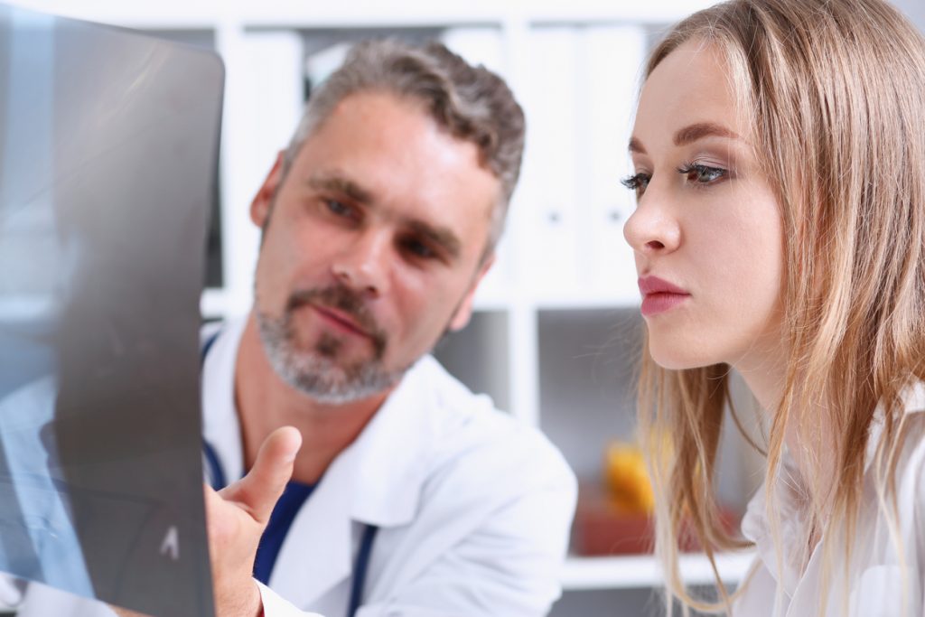 Medical Interpreter and Doctor looking at a computer screen