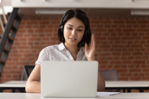 Woman using headset and laptop